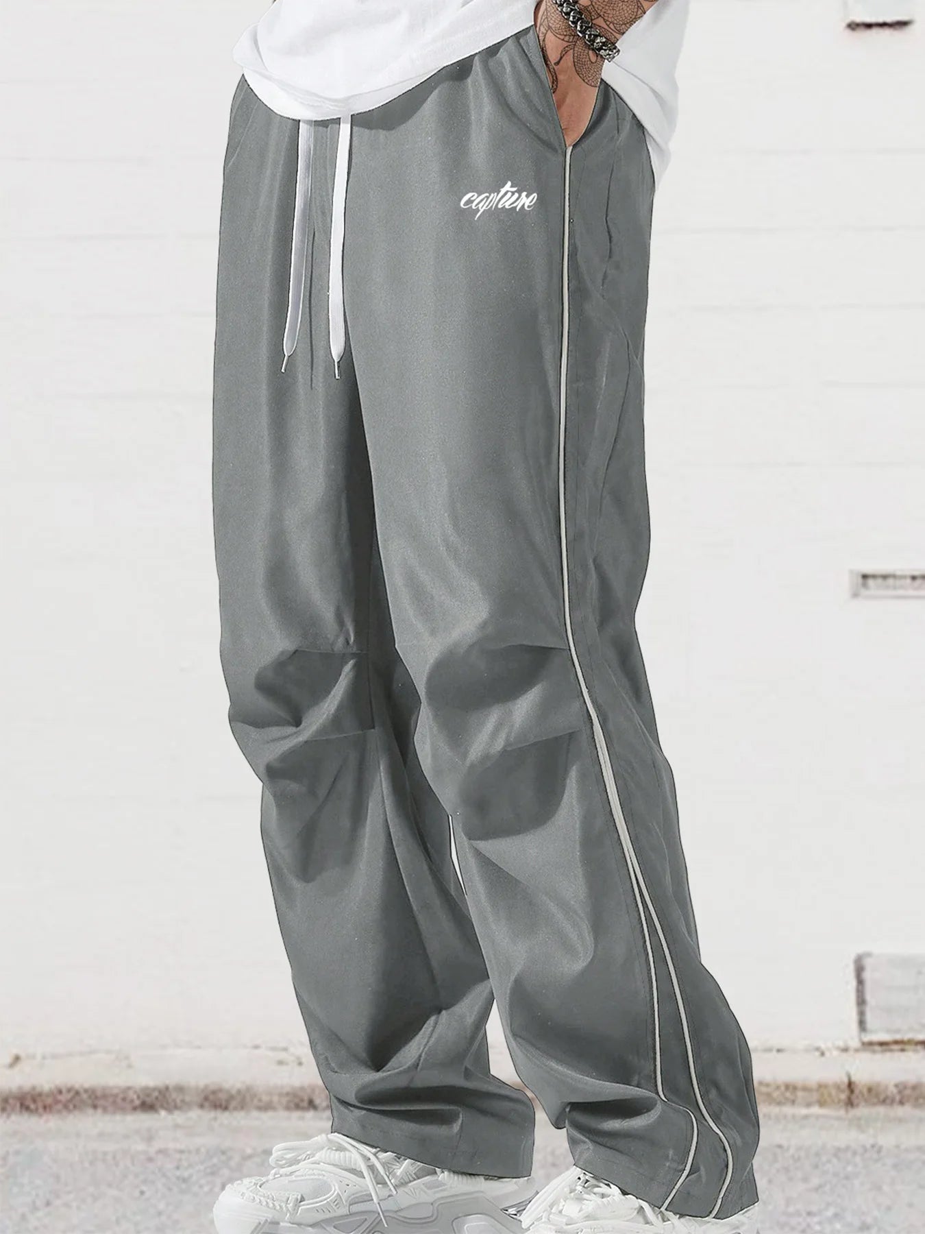 Men's gray wide-leg trousers with side stripe, drawstring waist, and white trim
