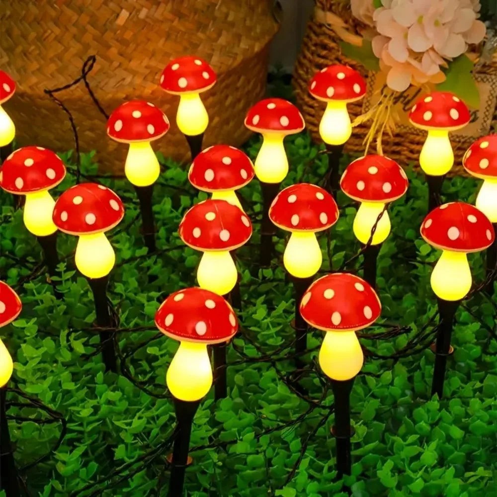 Solar mushroom garden light set: red mushroom caps with warm yellow glow bulbs on stakes