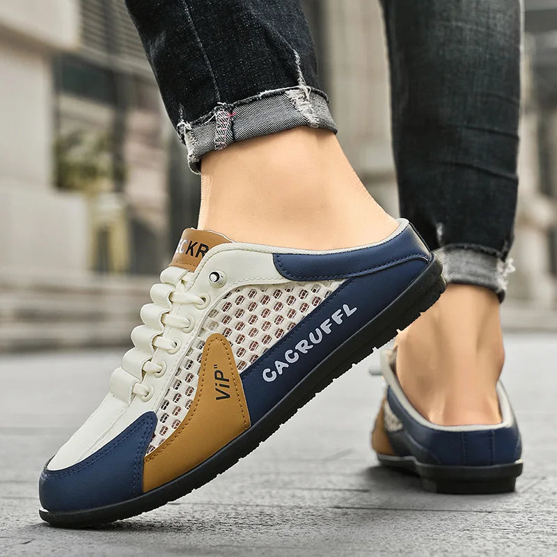 Men's mesh slip-on loafer shoes on foot, white with navy side and tan accent, closed toe.