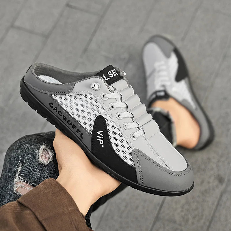Men's mesh slip-on loafer shoes on foot, light gray with dark panel accents, closed toe.