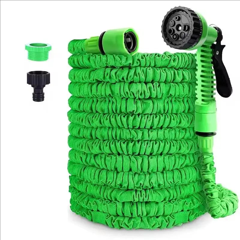 Expandable garden hose with green spray gun, green coiled hose, and two connectors