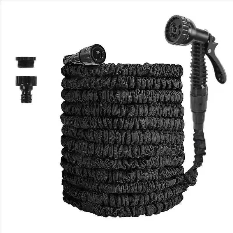 Expandable garden hose with black spray gun, black coiled hose, and two connectors