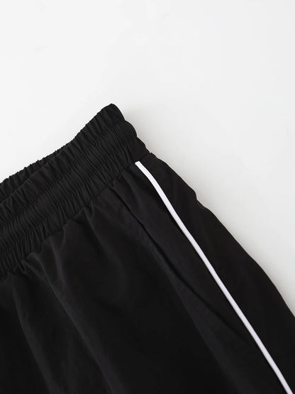 Black wide-leg trousers with elastic waistband and white drawstring cord