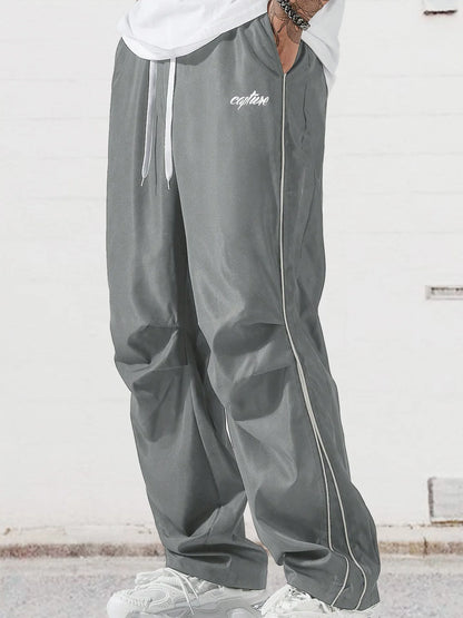 Men's gray wide-leg trousers with side stripe, drawstring waist, and white trim