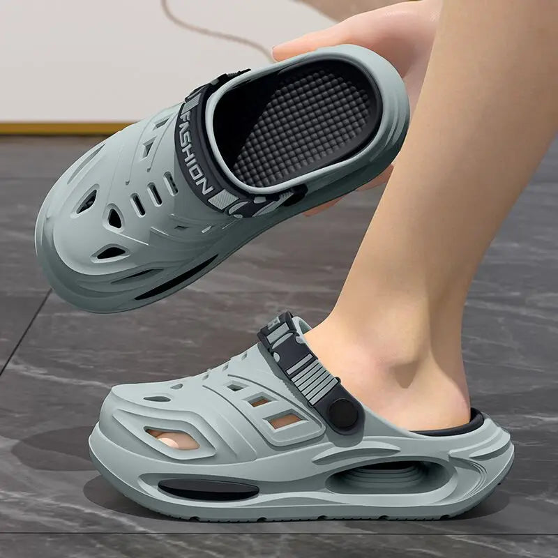Light blue anti-slip clogs with thick sole, vented upper, and adjustable strap