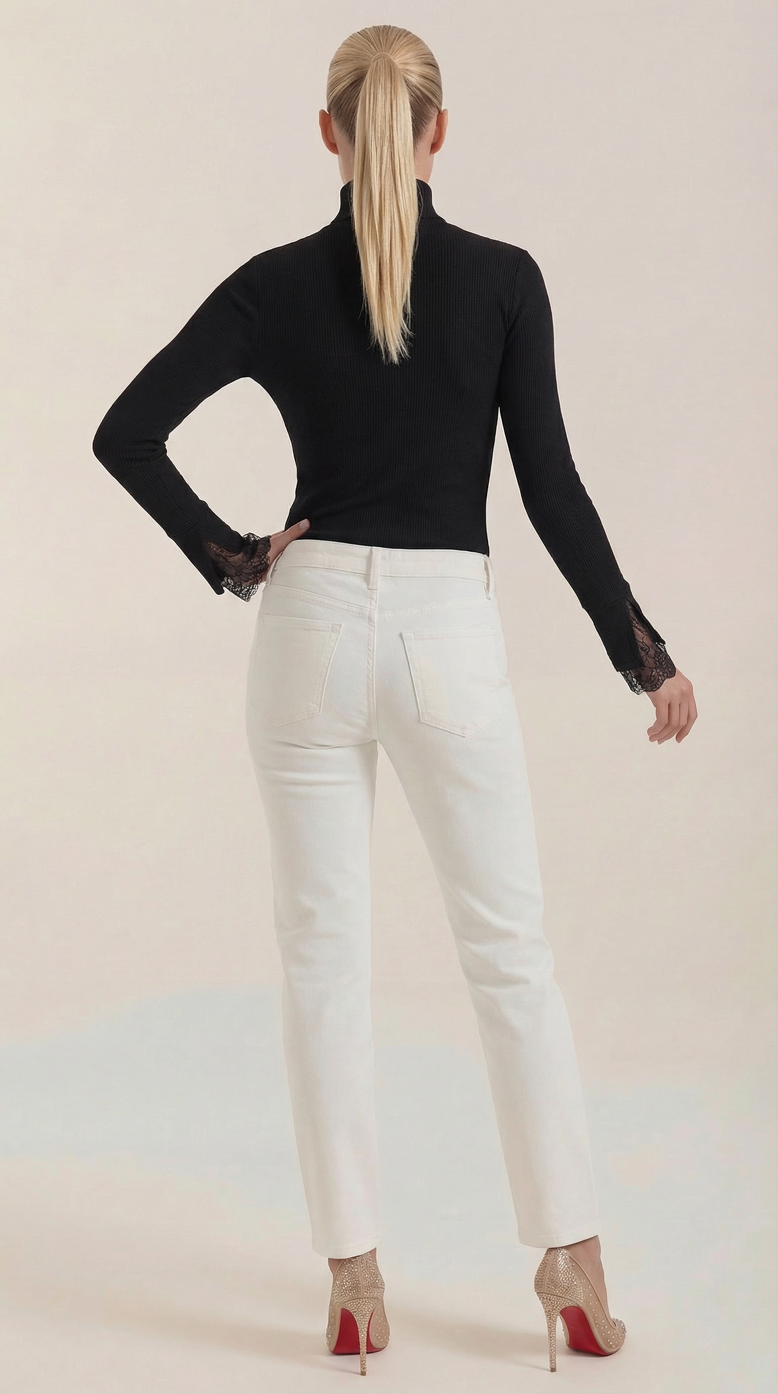 Black ribbed turtleneck top with lace cuffs on long sleeves, back view
