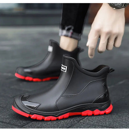 Men's waterproof black ankle boots with red outsole and pull tabs; low-cut profile