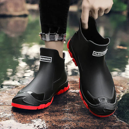 Men's waterproof black ankle boots with thick red tread sole and side logo label