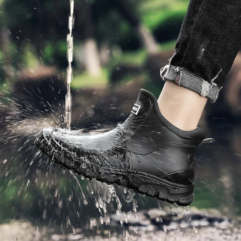 Men's waterproof black ankle boots with splash spray and textured tread sole