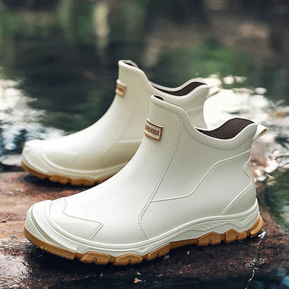 Men's waterproof beige ankle boots with pull tabs, side stitch, and tan tread sole
