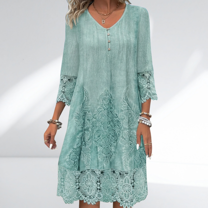 Embroidered lace tunic dress in teal green with buttoned V neckline and lace hem