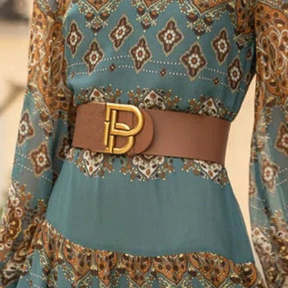 Bohemian maxi dress with long sleeves, teal print, and brown belt at waist