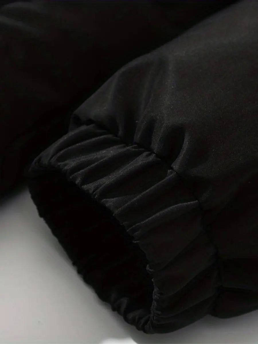 Women’s warm zip-up winter jacket sleeve detail, black padded fabric