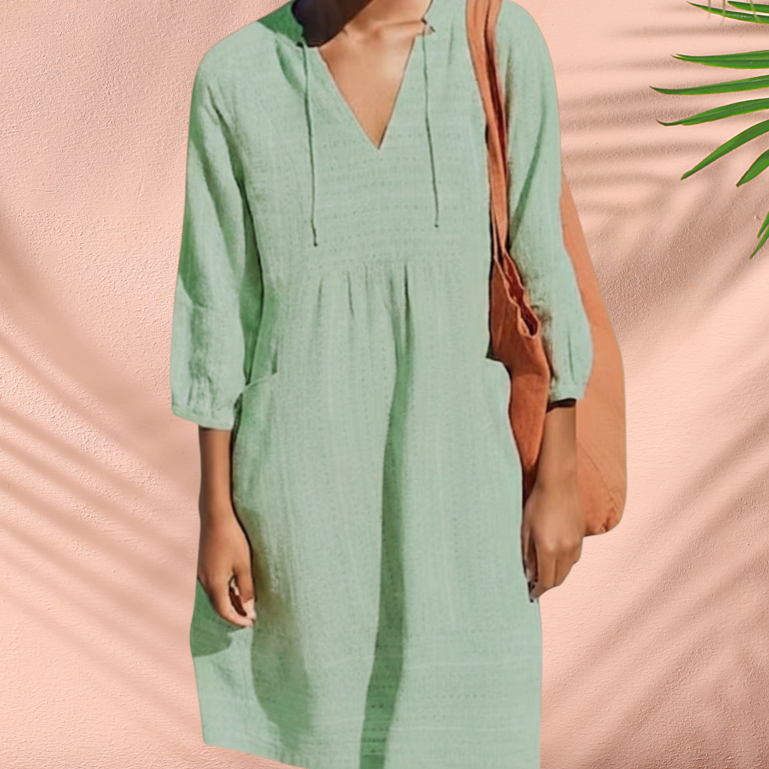 Green V-neck tunic dress with gathered waist and 3/4 sleeves, loose shift fit