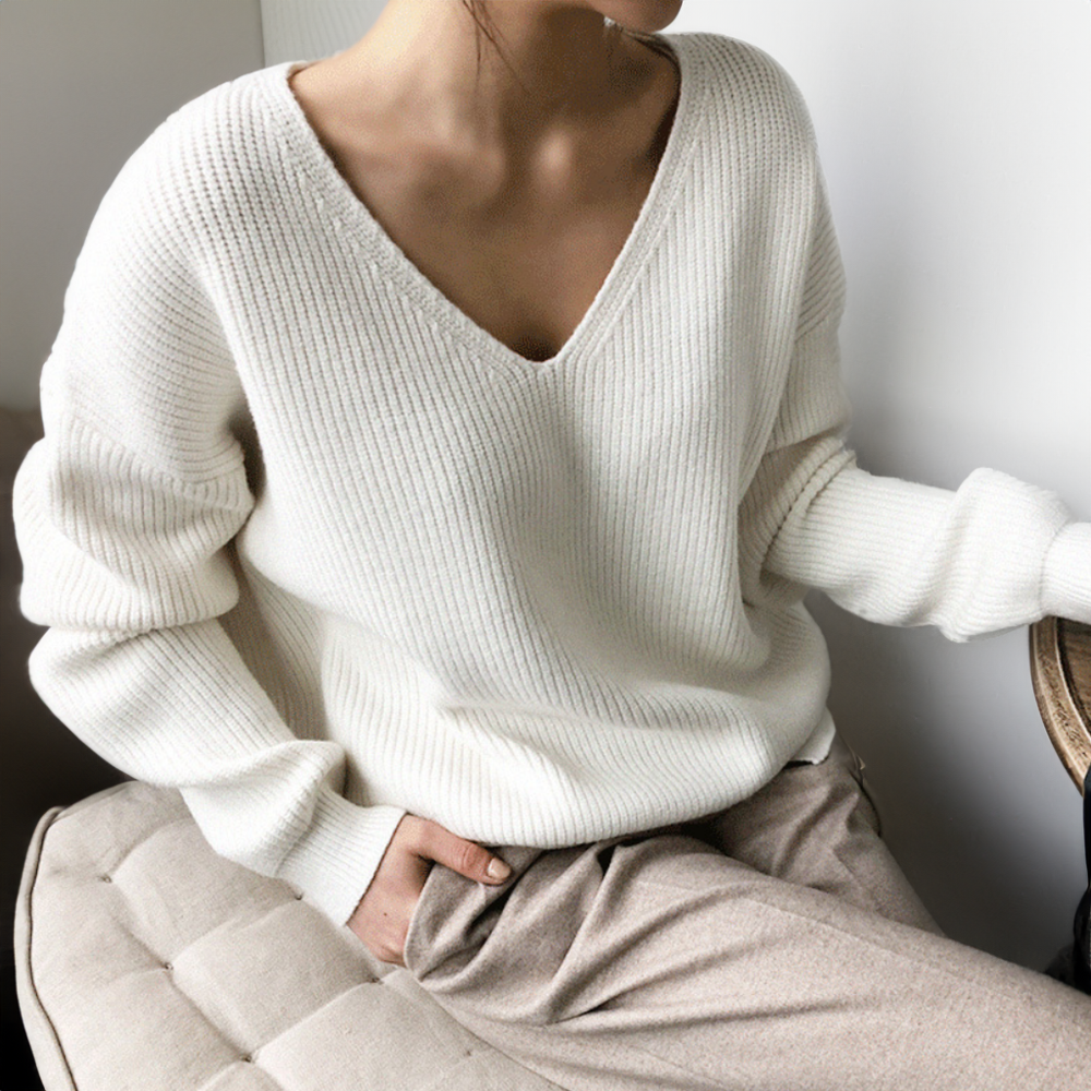 White V-neck knit sweater with long sleeves and ribbed knit texture