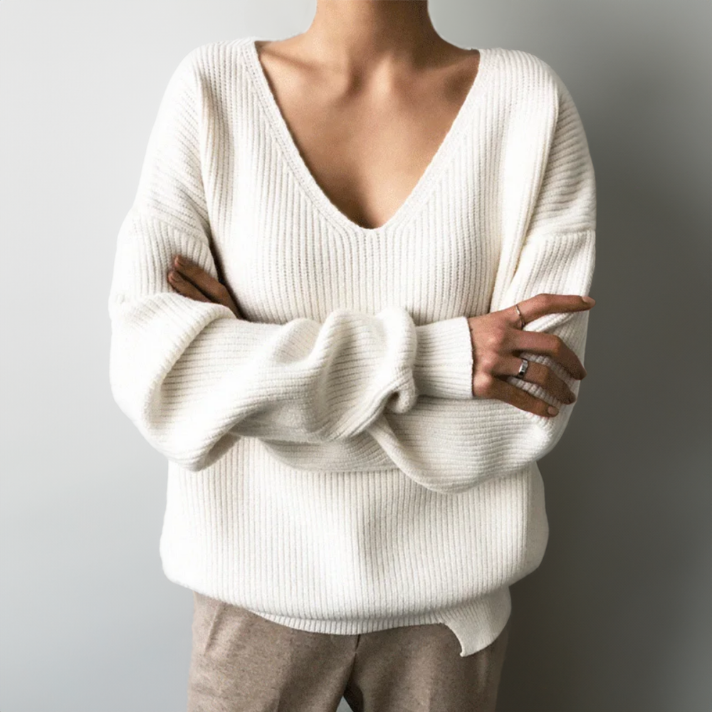 Cream/white V-neck cozy knit sweater with long sleeves and ribbed cuffs