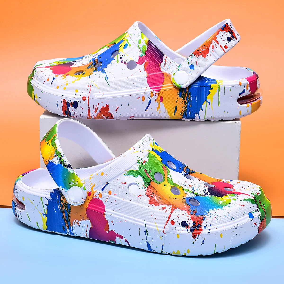 Ivory air-cushion clogs with multicolor paint-splatter print and thick sole