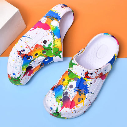 Ivory air-cushion clogs with multicolor paint-splatter, perforated footbed, thick sole