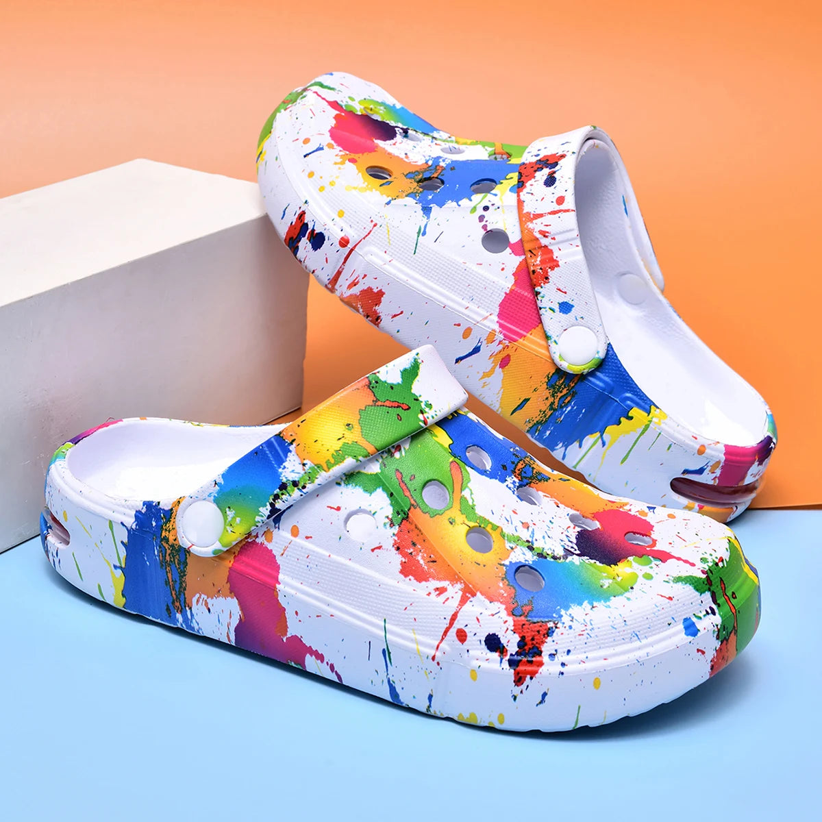 Ivory air-cushion clogs with paint-splatter print and slingback strap, thick sole
