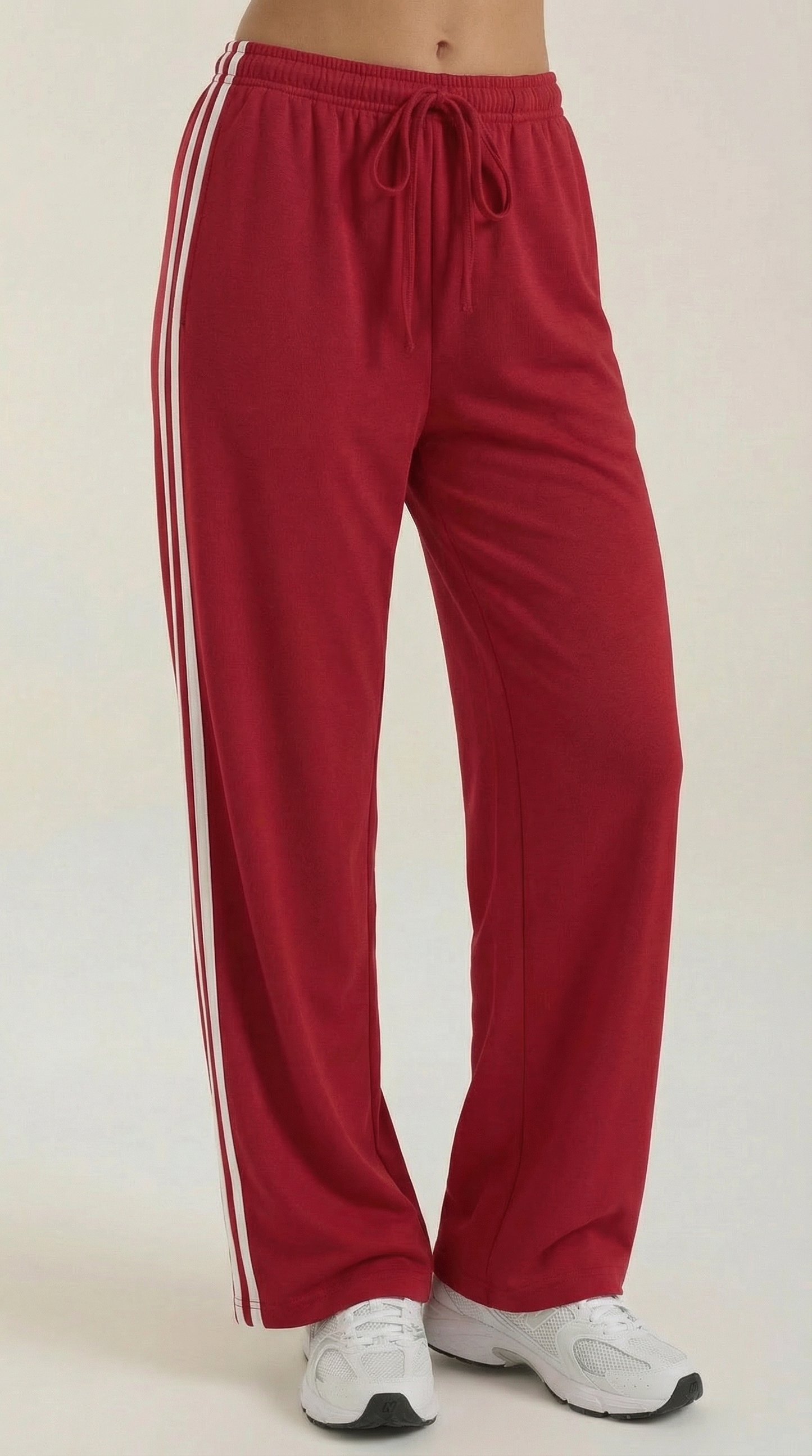 Red wide-leg track pants with elastic drawstring waist and white side stripe accents