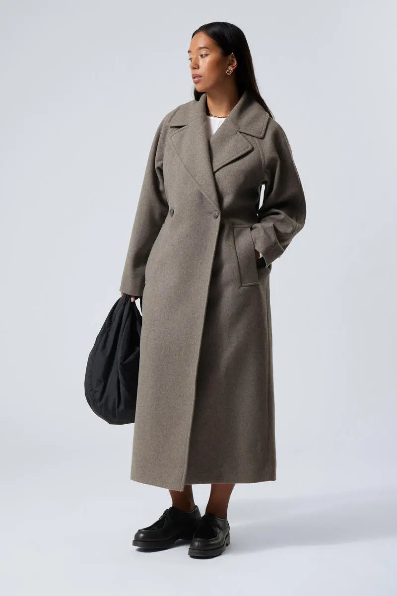 Women’s long oversized wool coat in grey with notched lapels and side button detail.