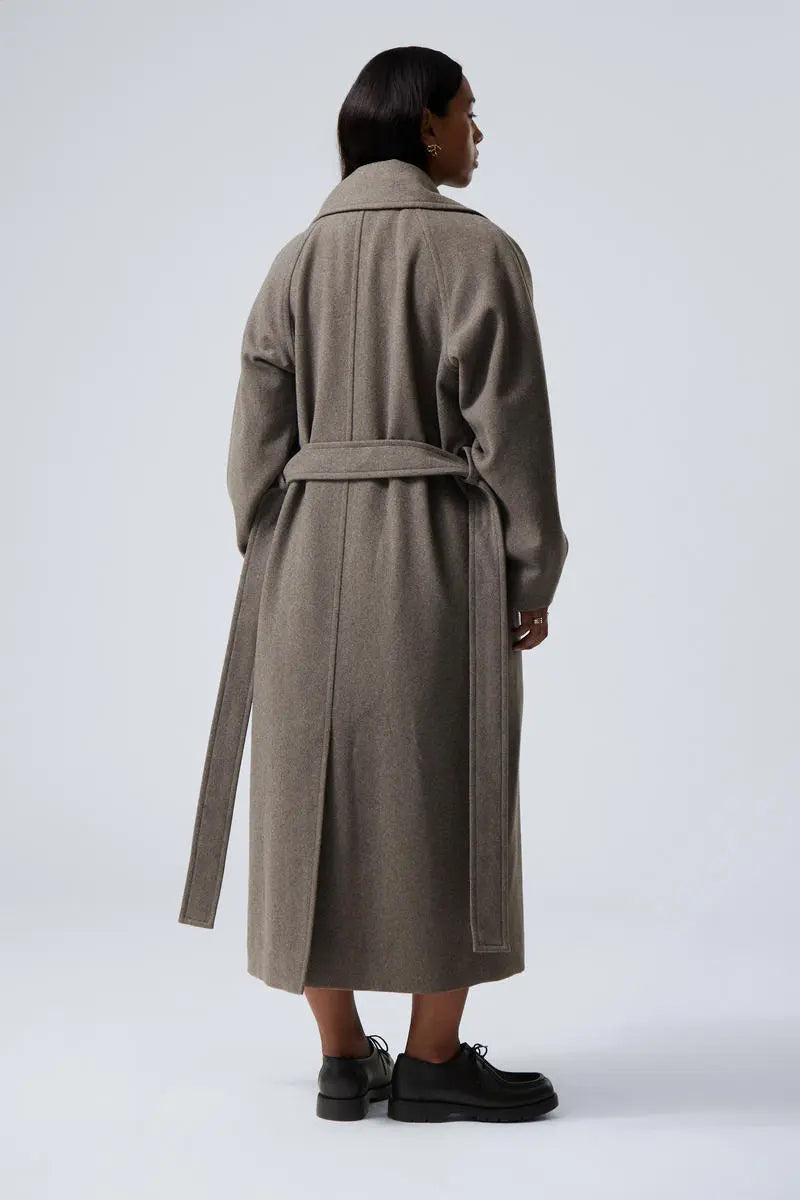 Women’s long oversized wool coat in grey with rear belt tie and notched collar.