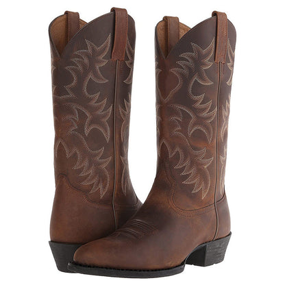 Women's brown western cowboy boots with embossed floral pattern and side pull tab