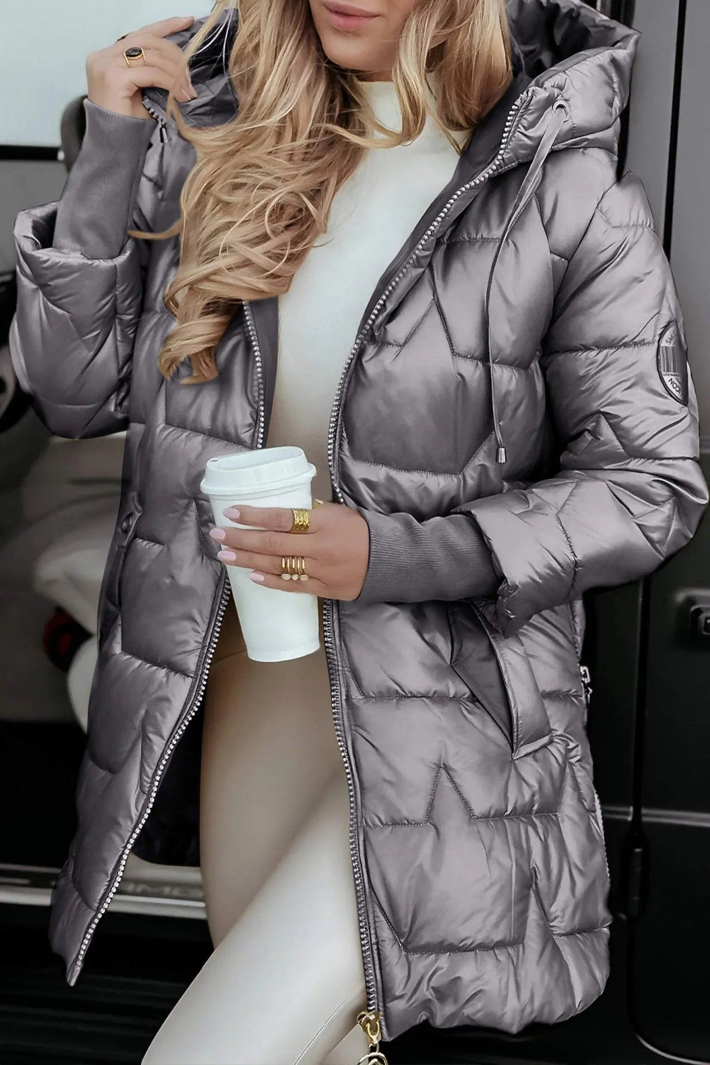 Grey hooded puffer jacket with full zip, quilted panels, and adjustable hood.