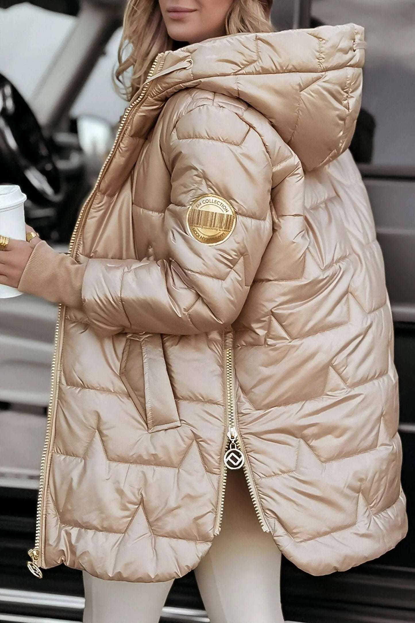 Light beige hooded puffer jacket with full zip and quilted hood.