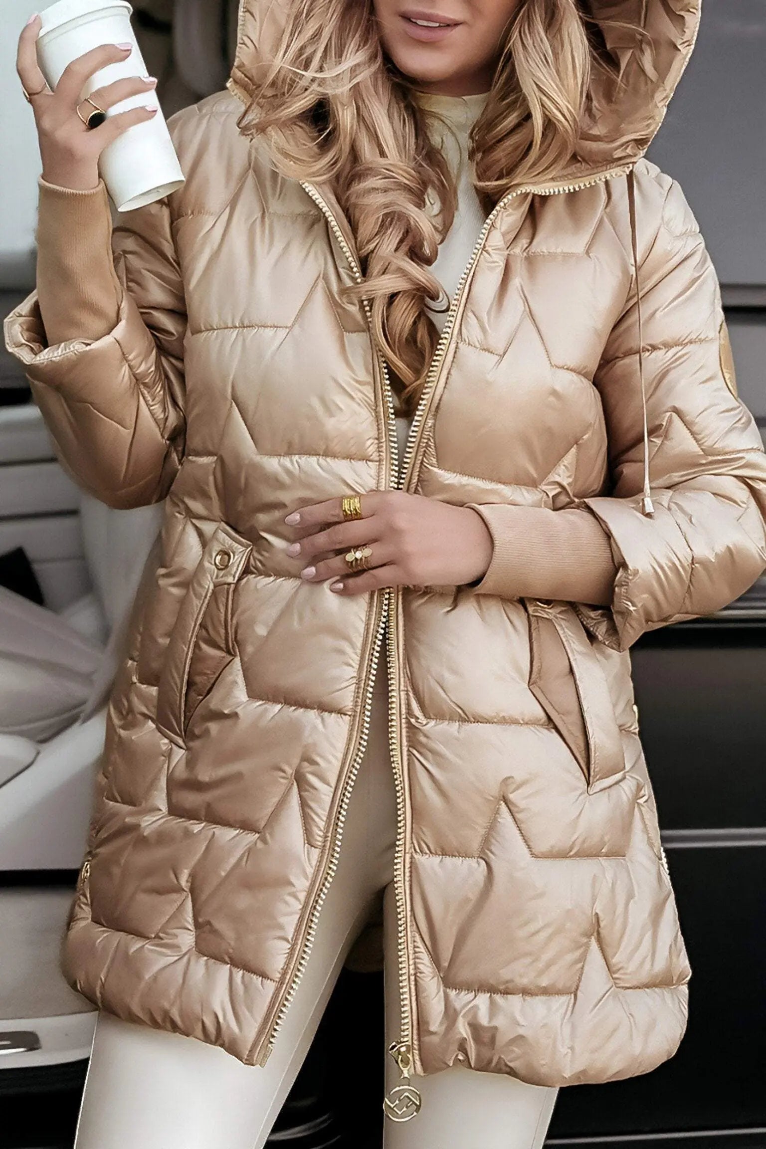 Tan hooded puffer jacket with full zip and quilted front panels.