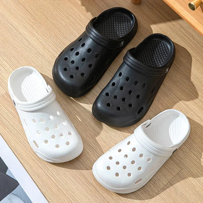 Unisex garden clogs in black and white, slip-on with ventilation holes and thick tread