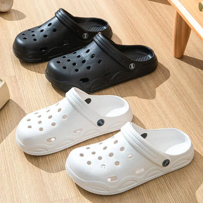 Black and white unisex garden clogs, slip-on slides with perforations and raised outsole