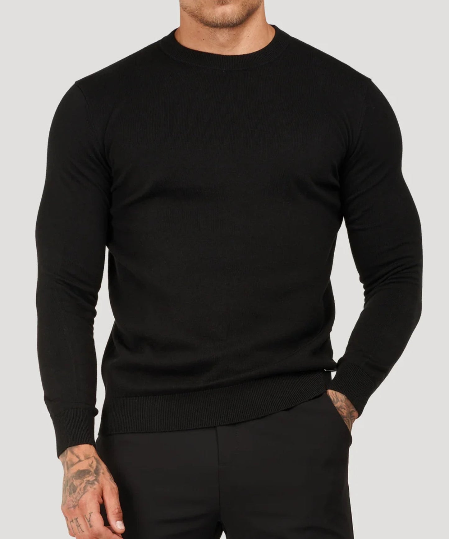 Black fine-knit roll-neck sweater with long sleeves and ribbed hem