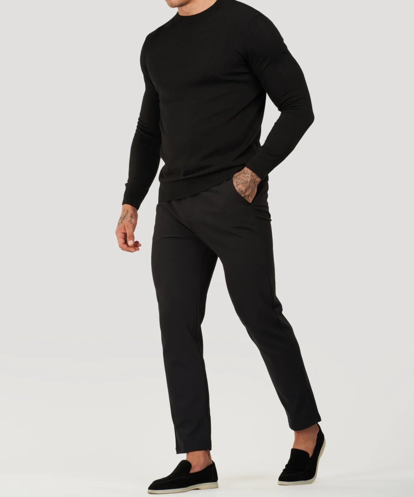 Black fine-knit roll-neck sweater with long sleeves and ribbed cuffs