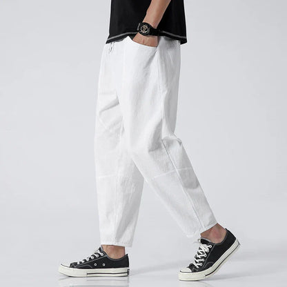 White cropped drawstring pants with elastic waistband, relaxed tapered fit