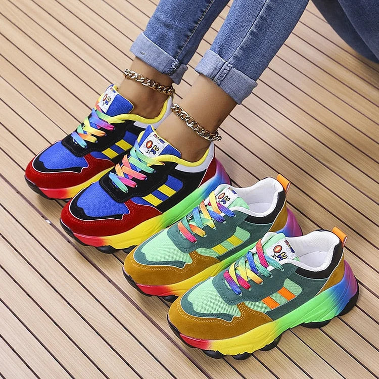 Pair of multicolor lace-up chunky sneakers with rainbow gradient soles and colorful laces