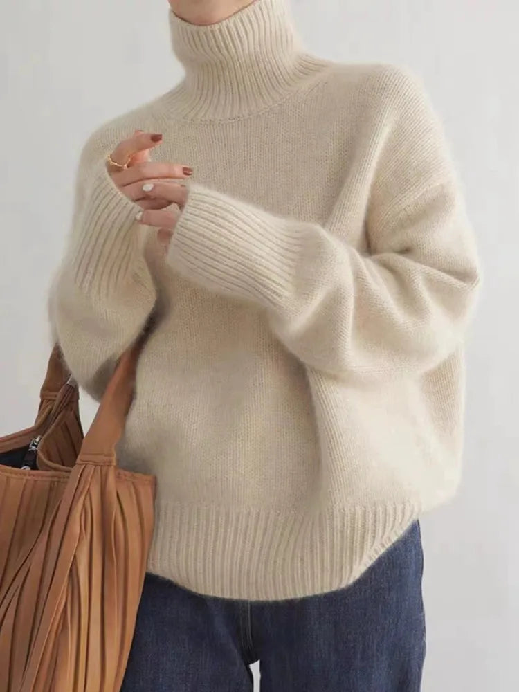 Beige turtleneck knit sweater with ribbed collar and relaxed sleeves