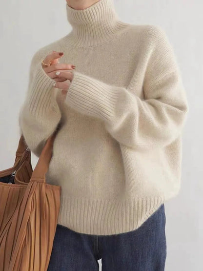 Beige turtleneck knit sweater with ribbed collar and relaxed sleeves