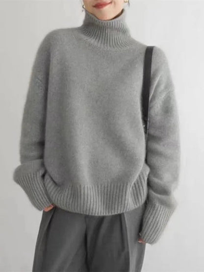 Gray turtleneck knit sweater with ribbed collar and wide cuffs