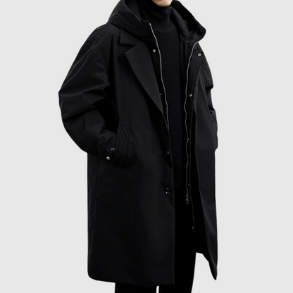 Men's black lightweight rain jacket with hood and front snap buttons, long length.