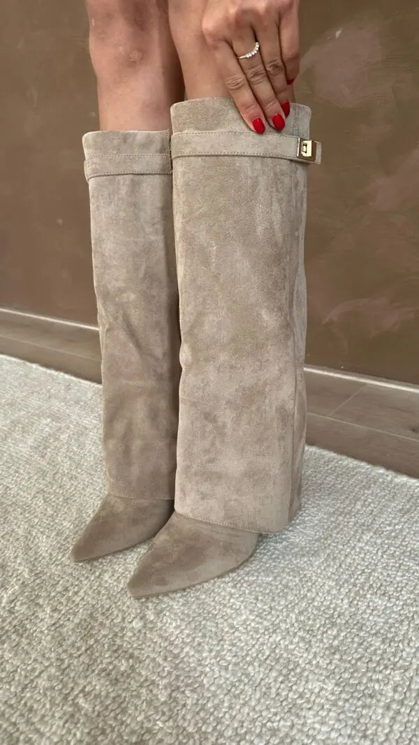 Women's taupe knee-high fold-over boots standing with square buckle side detail