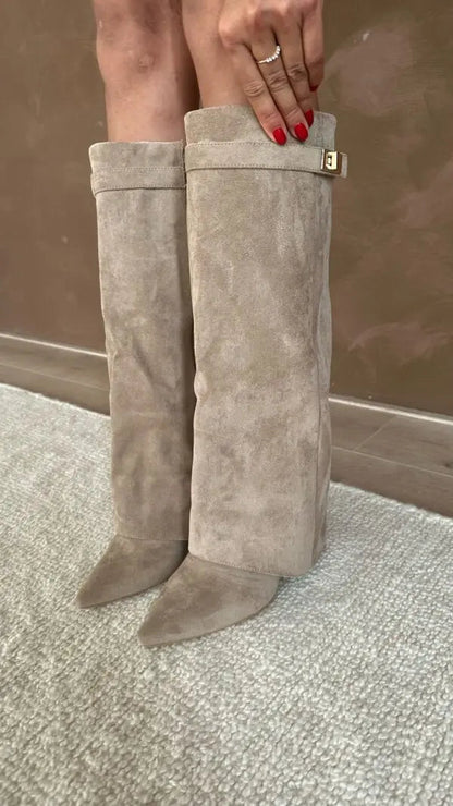 Women's taupe knee-high fold-over boots standing with square buckle side detail