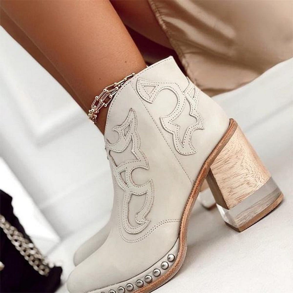 Women's western ankle boots in white with ornate stitchwork and silver-stud trim on shaft