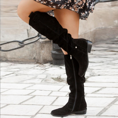 Black knee-high flat boots with smooth shaft and low stacked heel