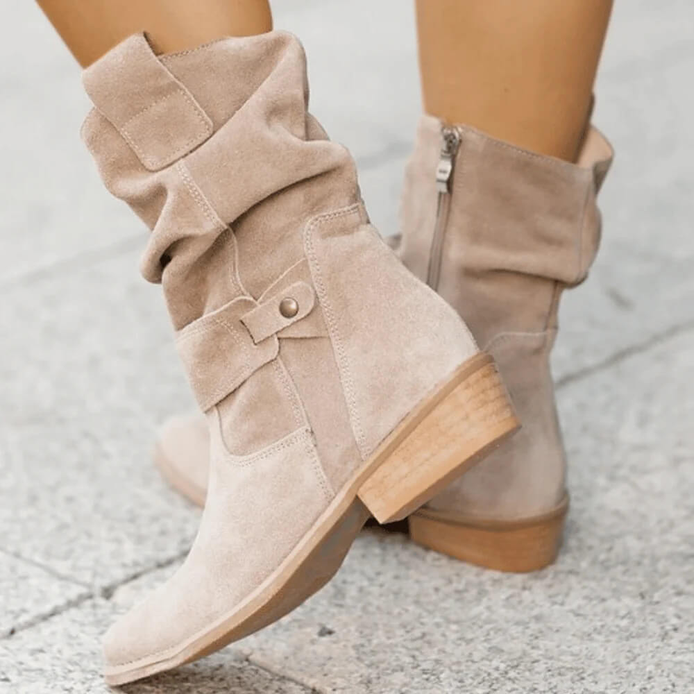 Beige suede slouch boots with side buckle strap and stacked low heel