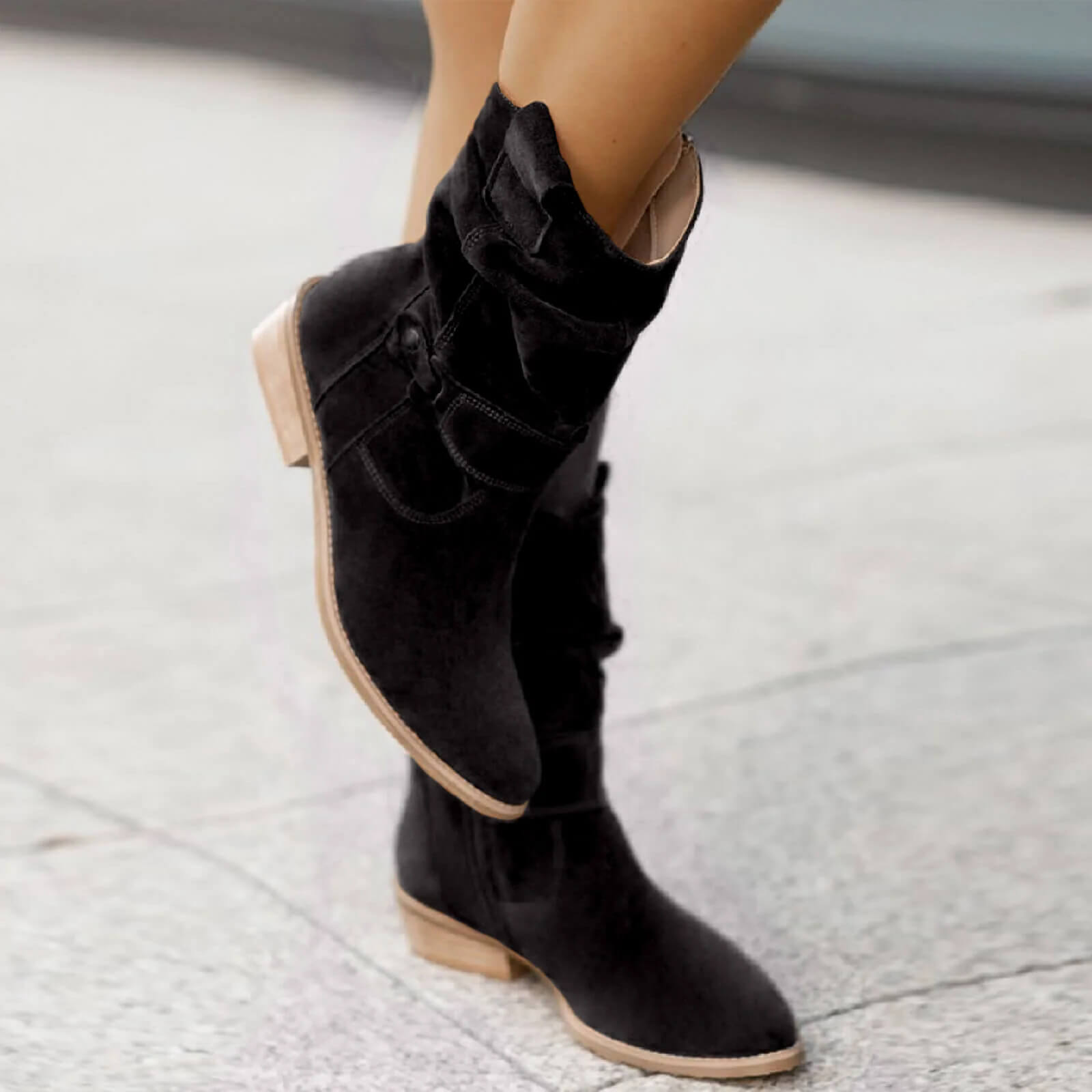 Black suede slouch boots with cuffed upper, side pull tab, and low heel