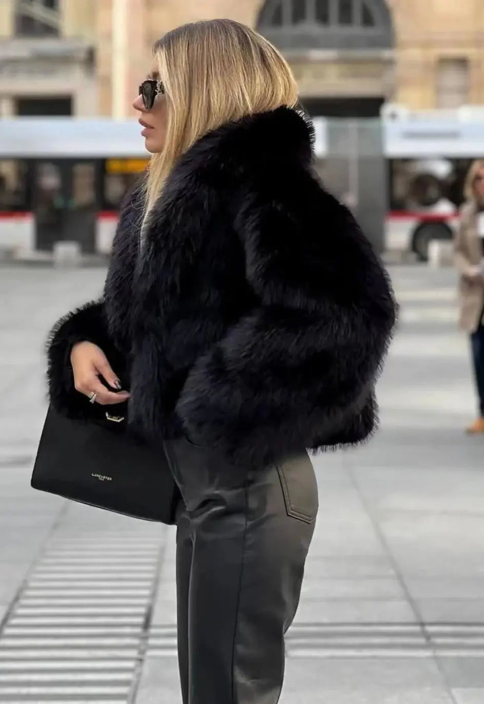 Black faux fur jacket with plush collar and long sleeves