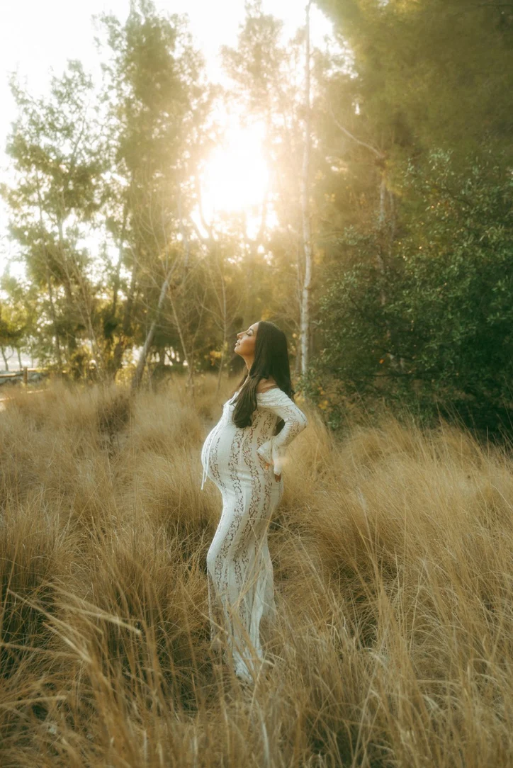 White lace maternity dress with flowing silhouette and off-shoulder neckline, rear view