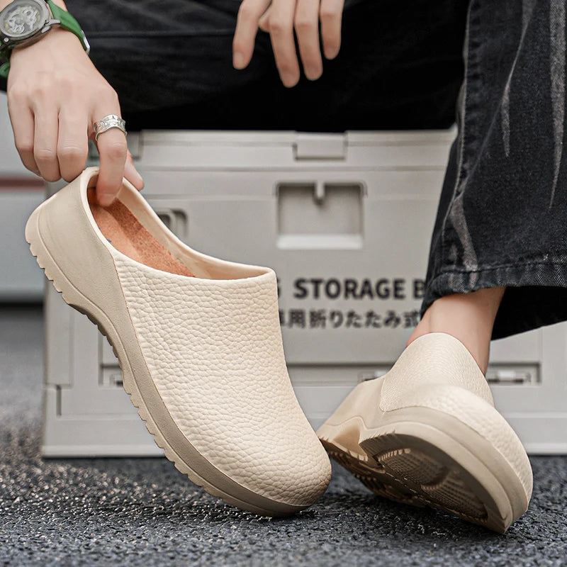 White textured slip-on clogs with open back, worn with jeans on pavement