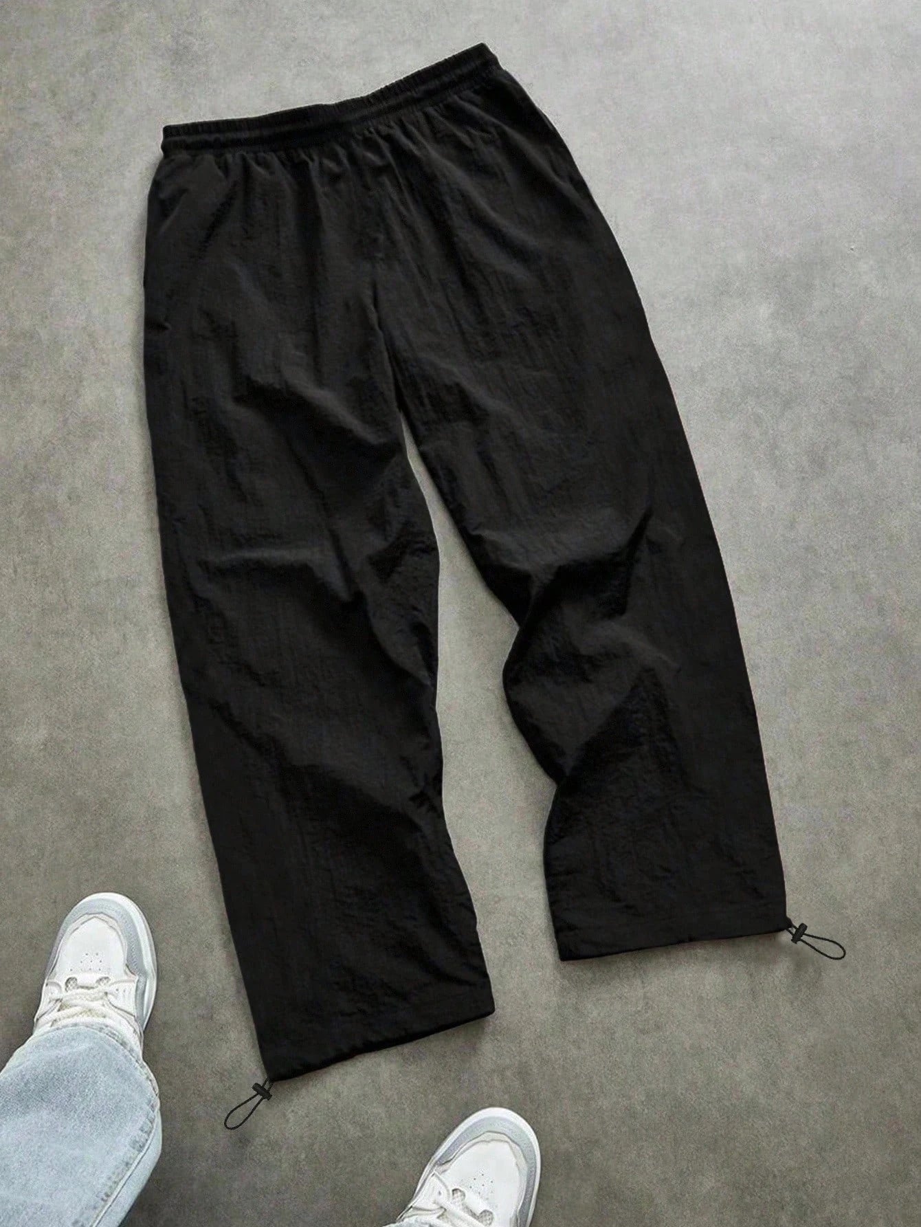 Men's quick-dry joggers, black with elastic waist, drawstring, and white side stripe